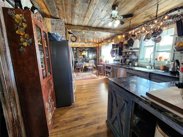 kitchen with ceiling fan, decorative light fixtures, hardwood / wood-style floors, stainless steel appliances, and wooden ceiling