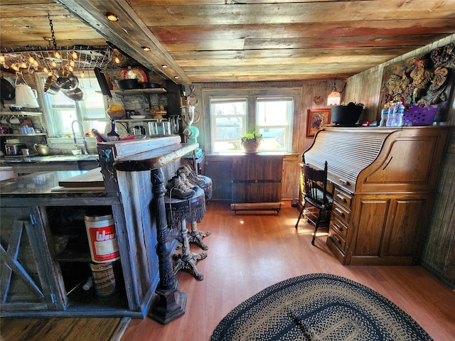 interior space with wood walls, dark hardwood / wood-style flooring, a notable chandelier, and wooden ceiling