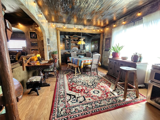 dining room with light hardwood / wood-style floors and wooden ceiling