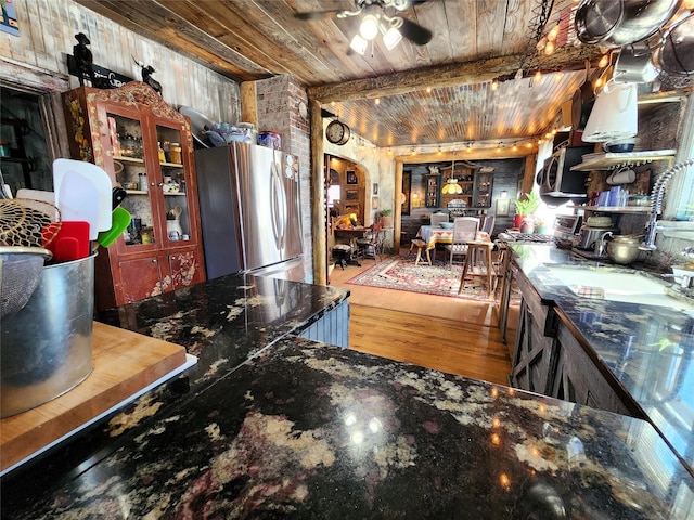 116 3rd Ave NE, Dutton, MT 59433 - kitchen featuring stainless steel appliances, wood ceiling, a ceiling fan, arched walkways, and wood finished floors