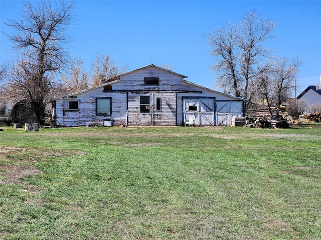 116 3rd Ave NE, Dutton, MT 59433 - back of property with a barn, a lawn, and an outdoor structure