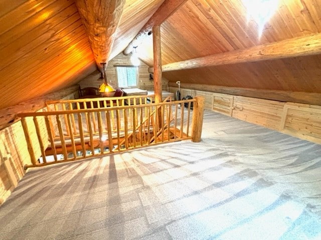 additional living space featuring carpet flooring, wooden ceiling, and vaulted ceiling