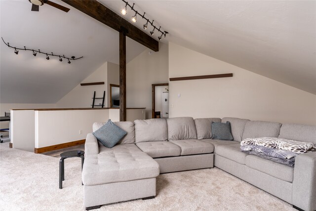 carpeted living room with lofted ceiling with beams, ceiling fan, and track lighting