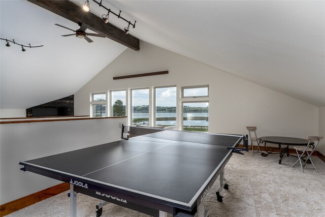 rec room with lofted ceiling with beams, a water view, track lighting, light colored carpet, and ceiling fan