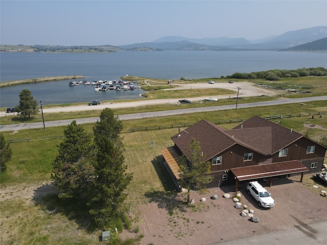 birds eye view of property featuring a water and mountain view