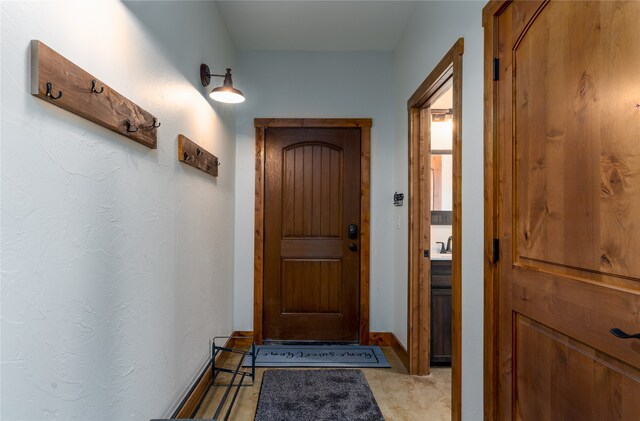 doorway featuring light carpet