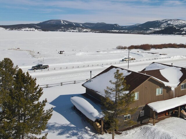 snowy aerial view featuring a mountain view