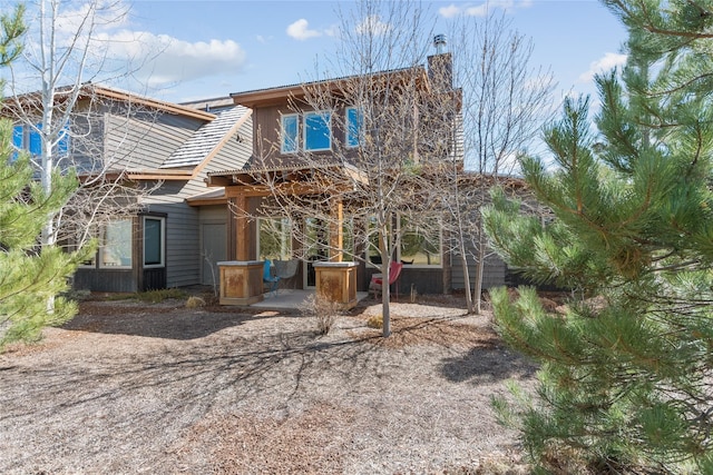 87 Rusty Iron Way, Eureka, MT 59917 - rear view of property with a chimney and a patio area