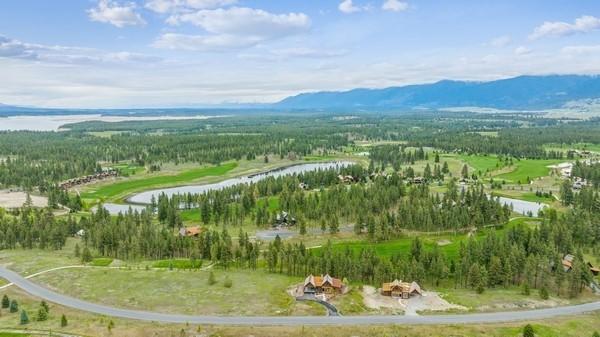 87 Rusty Iron Way, Eureka, MT 59917 - aerial view of property and surrounding area featuring a water and mountain view and a heavily wooded area