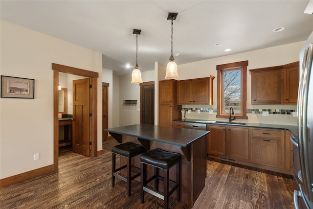 87 Rusty Iron Way, Eureka, MT 59917 - kitchen featuring a kitchen island, pendant lighting, dark wood-type flooring, and backsplash
