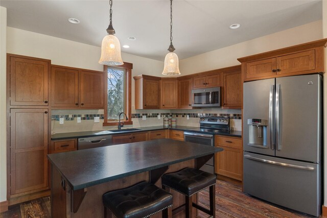 87 Rusty Iron Way, Eureka, MT 59917 - kitchen with appliances with stainless steel finishes, dark countertops, backsplash, brown cabinets, and recessed lighting