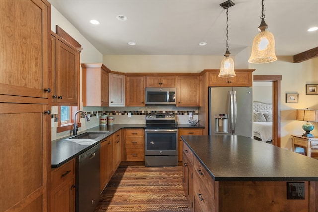 87 Rusty Iron Way, Eureka, MT 59917 - kitchen featuring a kitchen island, dark hardwood / wood-style floors, sink, hanging light fixtures, and appliances with stainless steel finishes