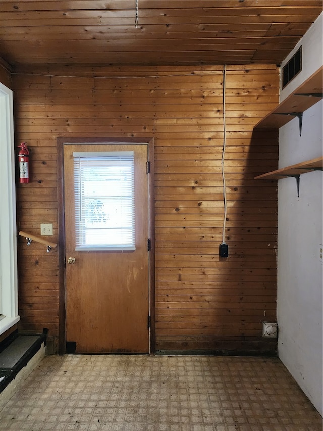 entryway featuring wood walls and wooden ceiling