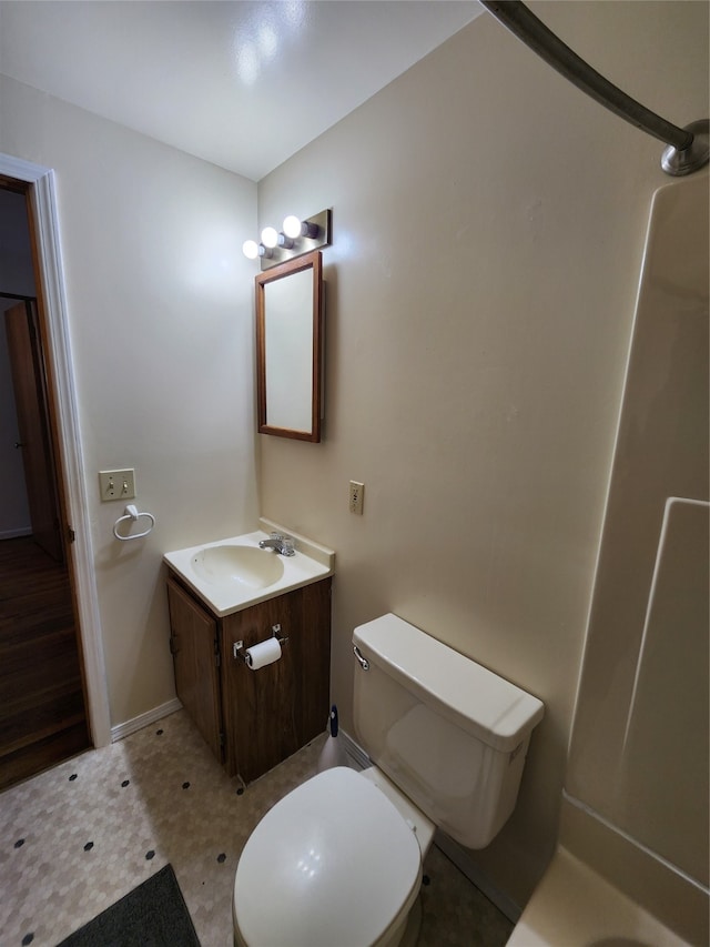 bathroom with a shower, vanity, and toilet