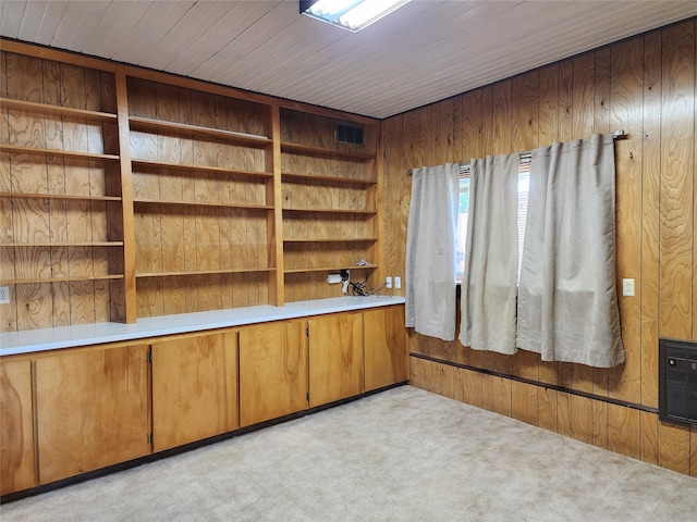 unfurnished office with wooden walls and light carpet