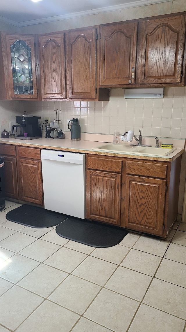 kitchen with dishwasher, crown molding, decorative backsplash, and sink