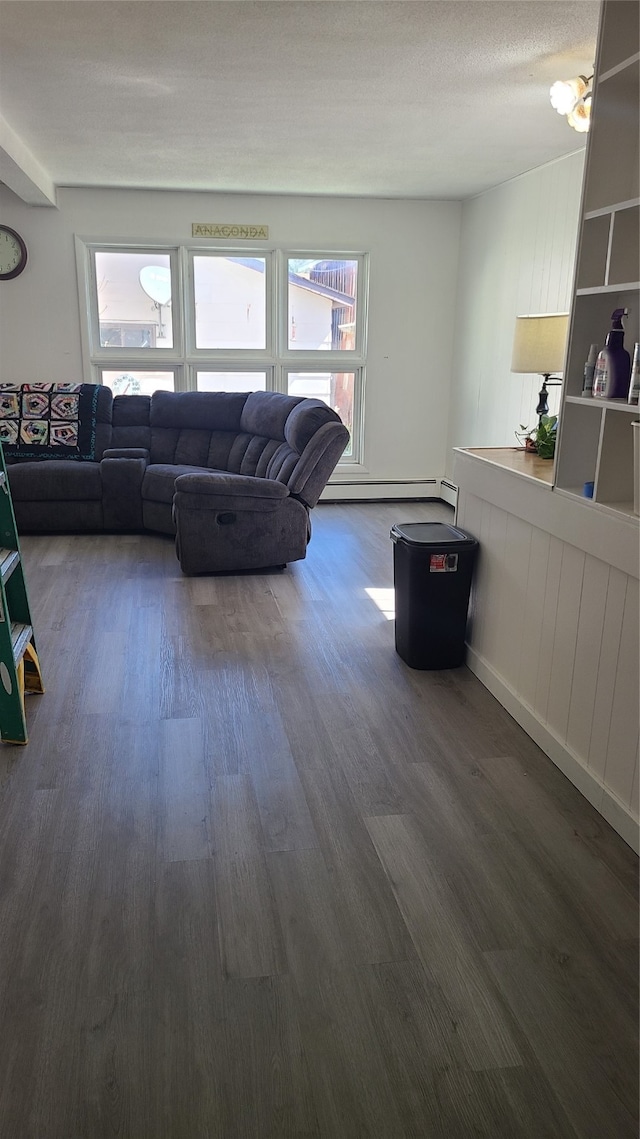 living room featuring a textured ceiling, a baseboard radiator, and dark hardwood / wood-style floors