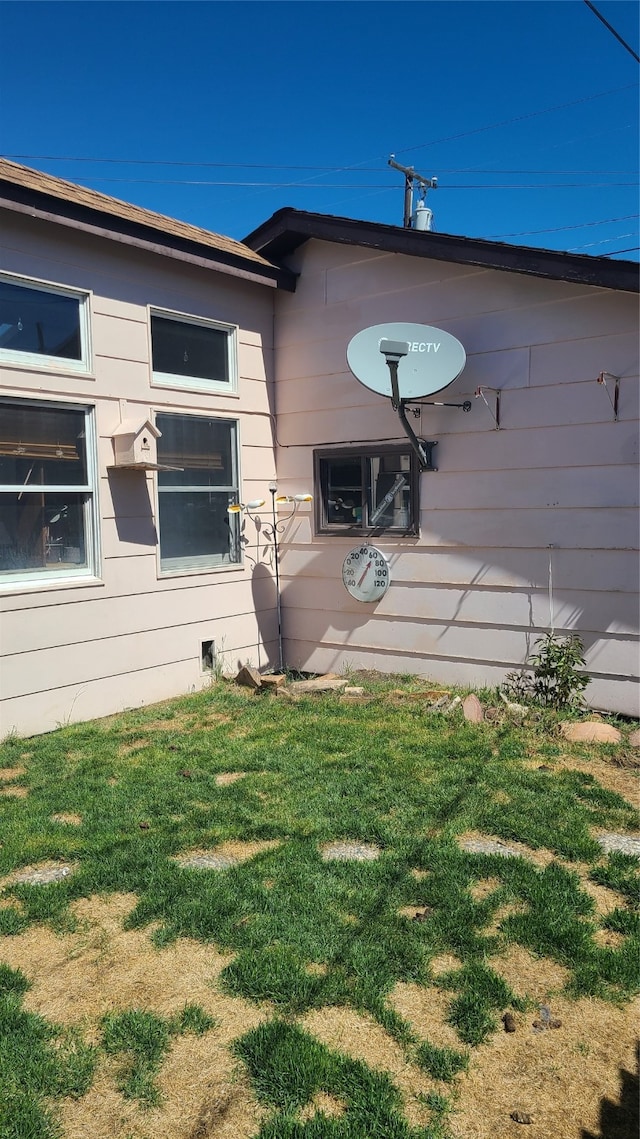 view of home's exterior with a yard