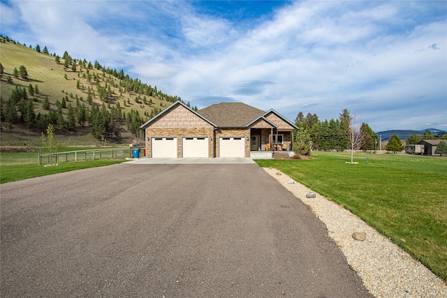 view of front of property with a garage and a front lawn