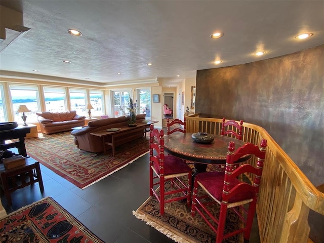 tiled dining space with a textured ceiling