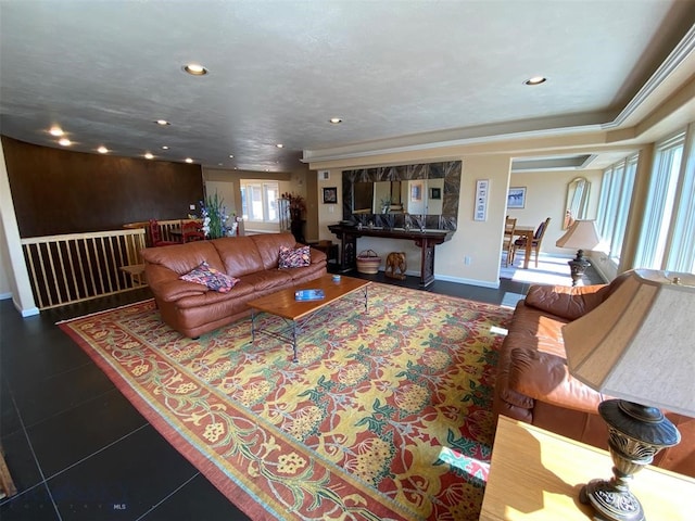 living room featuring dark tile flooring and a tray ceiling