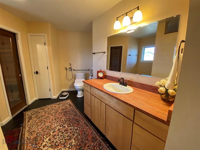 bathroom with vanity with extensive cabinet space, toilet, and tile flooring