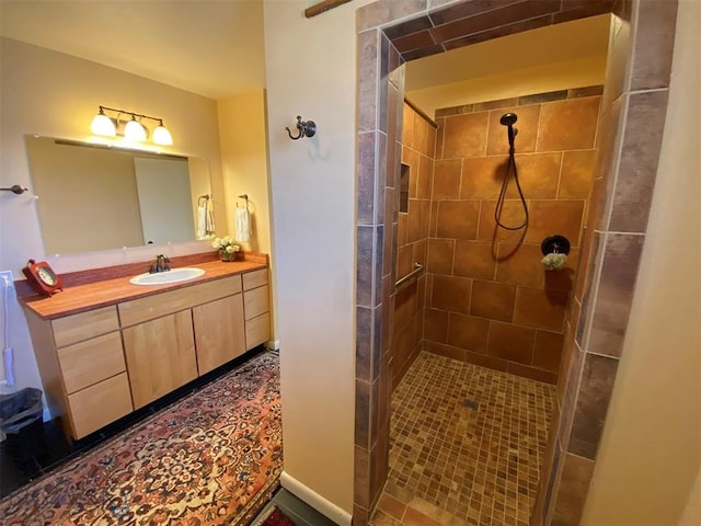 bathroom featuring vanity and a tile shower