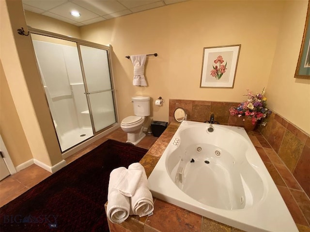 bathroom featuring toilet, tile floors, separate shower and tub, and a paneled ceiling