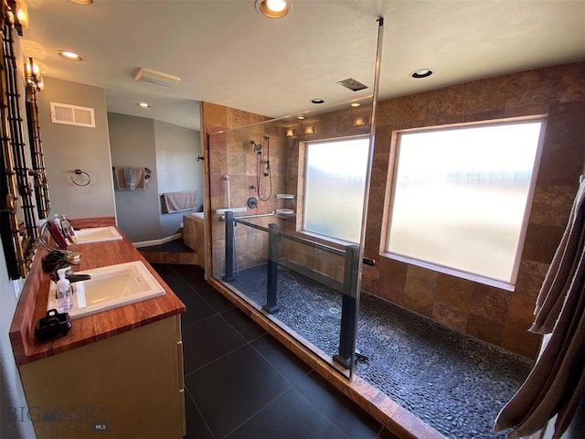 bathroom with oversized vanity, an enclosed shower, and tile flooring