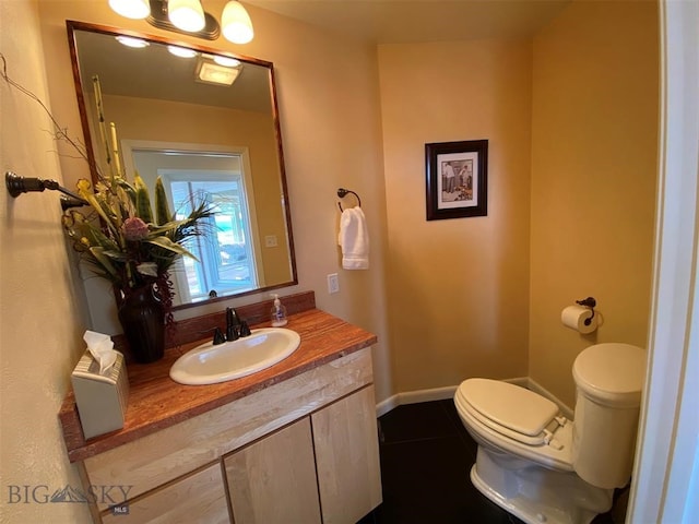 bathroom with oversized vanity, toilet, and tile flooring