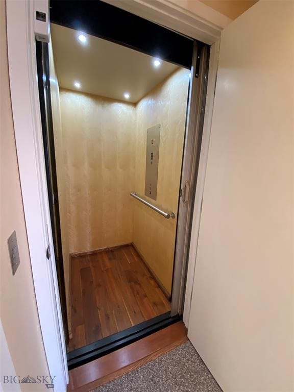 room details featuring hardwood / wood-style floors and elevator