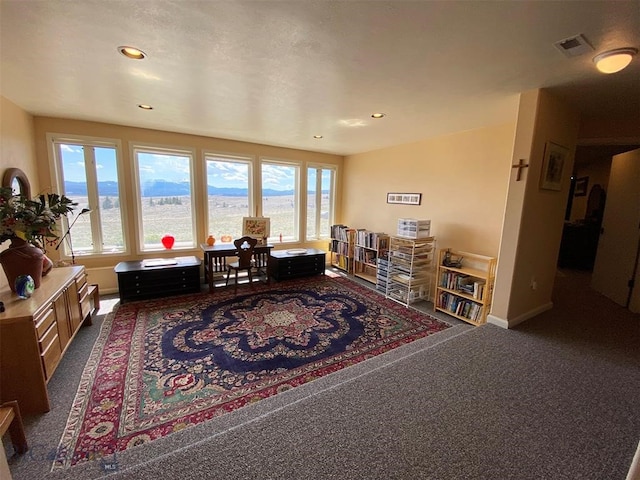 carpeted living room with plenty of natural light and a water view