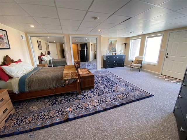 bedroom with carpet and a paneled ceiling