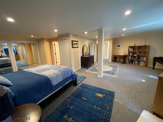 carpeted bedroom featuring multiple closets