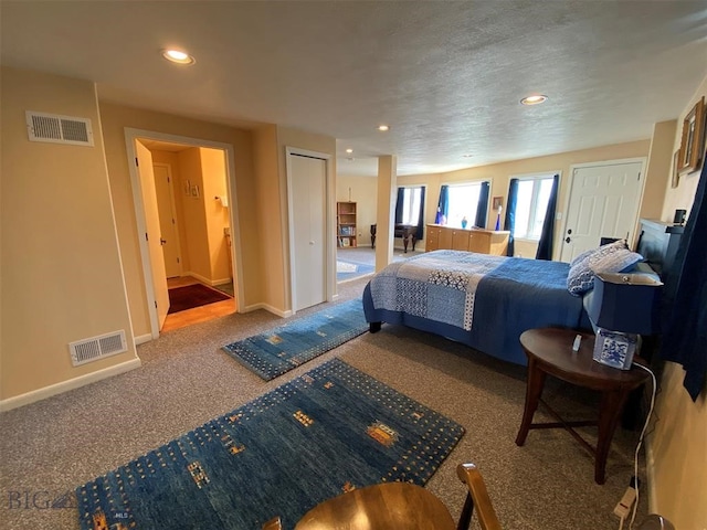 carpeted bedroom featuring ensuite bathroom