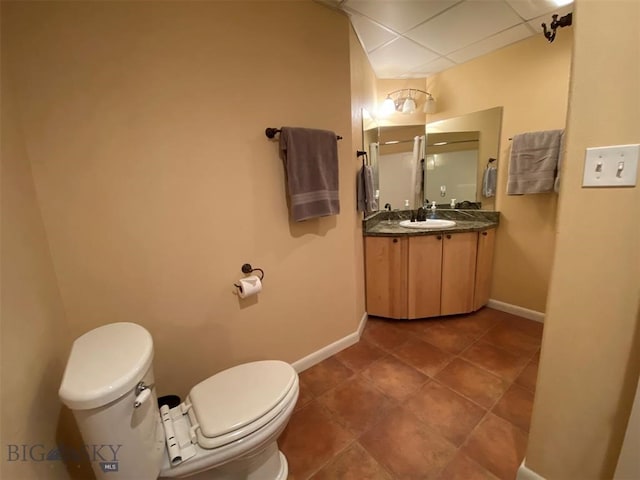 bathroom with large vanity, toilet, and tile flooring