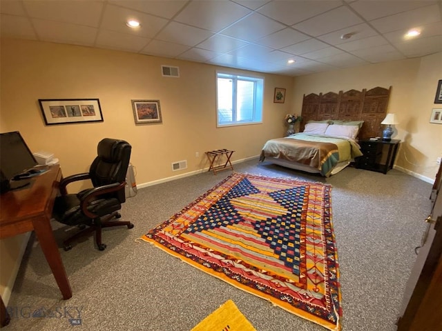 carpeted bedroom with a paneled ceiling