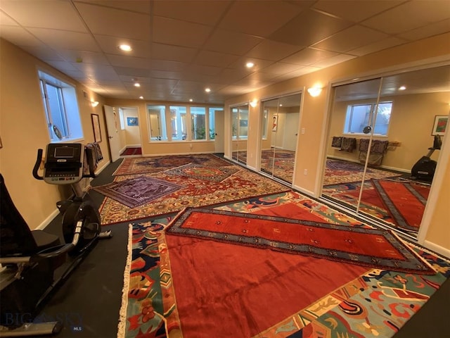 interior space featuring plenty of natural light, carpet, and a paneled ceiling