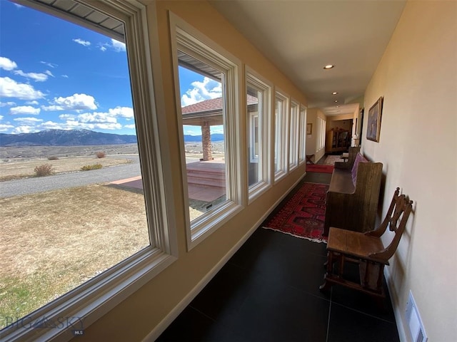 sunroom / solarium with a mountain view