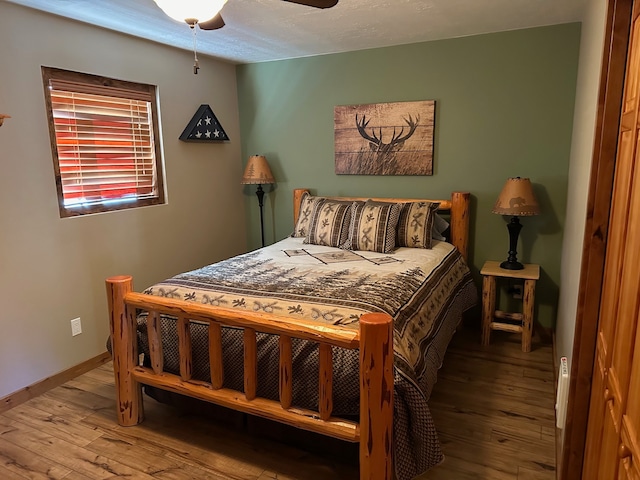 bedroom with wood-type flooring and ceiling fan