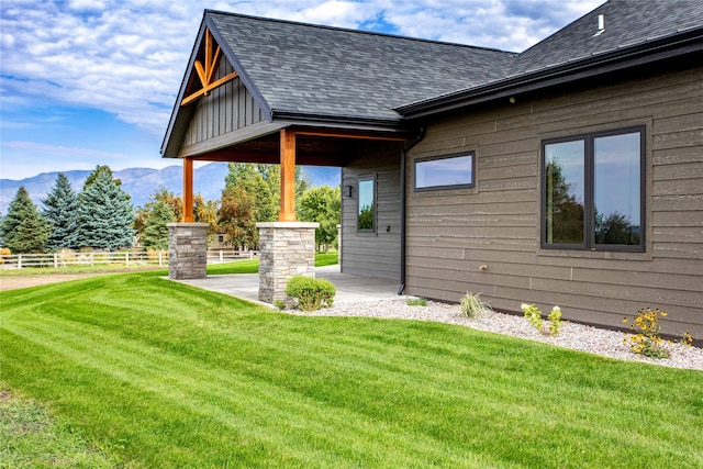 exterior space with a lawn and a mountain view