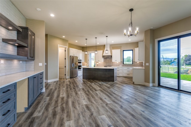 kitchen with hanging light fixtures, white cabinets, dark hardwood / wood-style flooring, a center island, and stainless steel refrigerator with ice dispenser