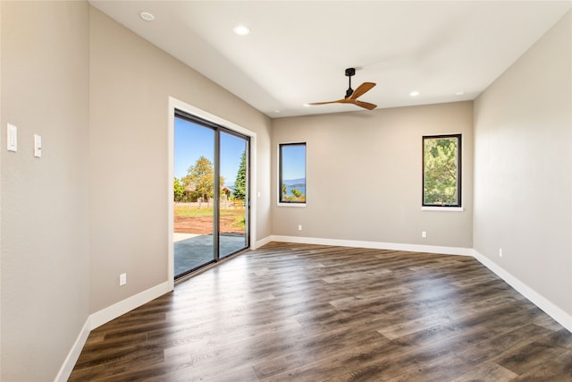 unfurnished room featuring ceiling fan and dark hardwood / wood-style floors