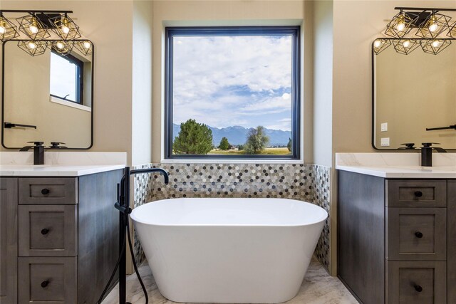 114 Pheasant Ridge Ct, Polson, MT 59860 - full bath featuring tile walls, a freestanding bath, two vanities, a wainscoted wall, and a mountain view
