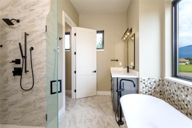114 Pheasant Ridge Ct, Polson, MT 59860 - bathroom featuring a tile shower, a freestanding tub, vanity, and marble finish flooring