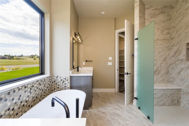 bathroom featuring shower with separate bathtub and vanity