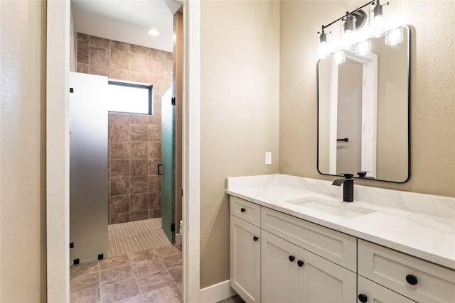 bathroom featuring vanity and a shower with shower door