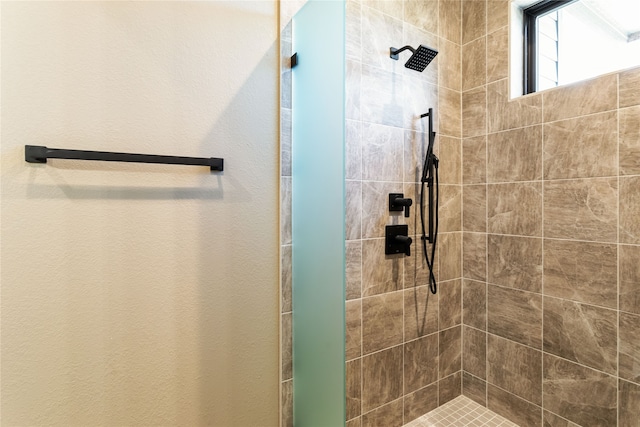 bathroom with a tile shower