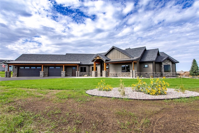 craftsman house featuring a front yard and a garage