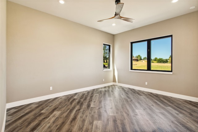 spare room with ceiling fan and hardwood / wood-style flooring